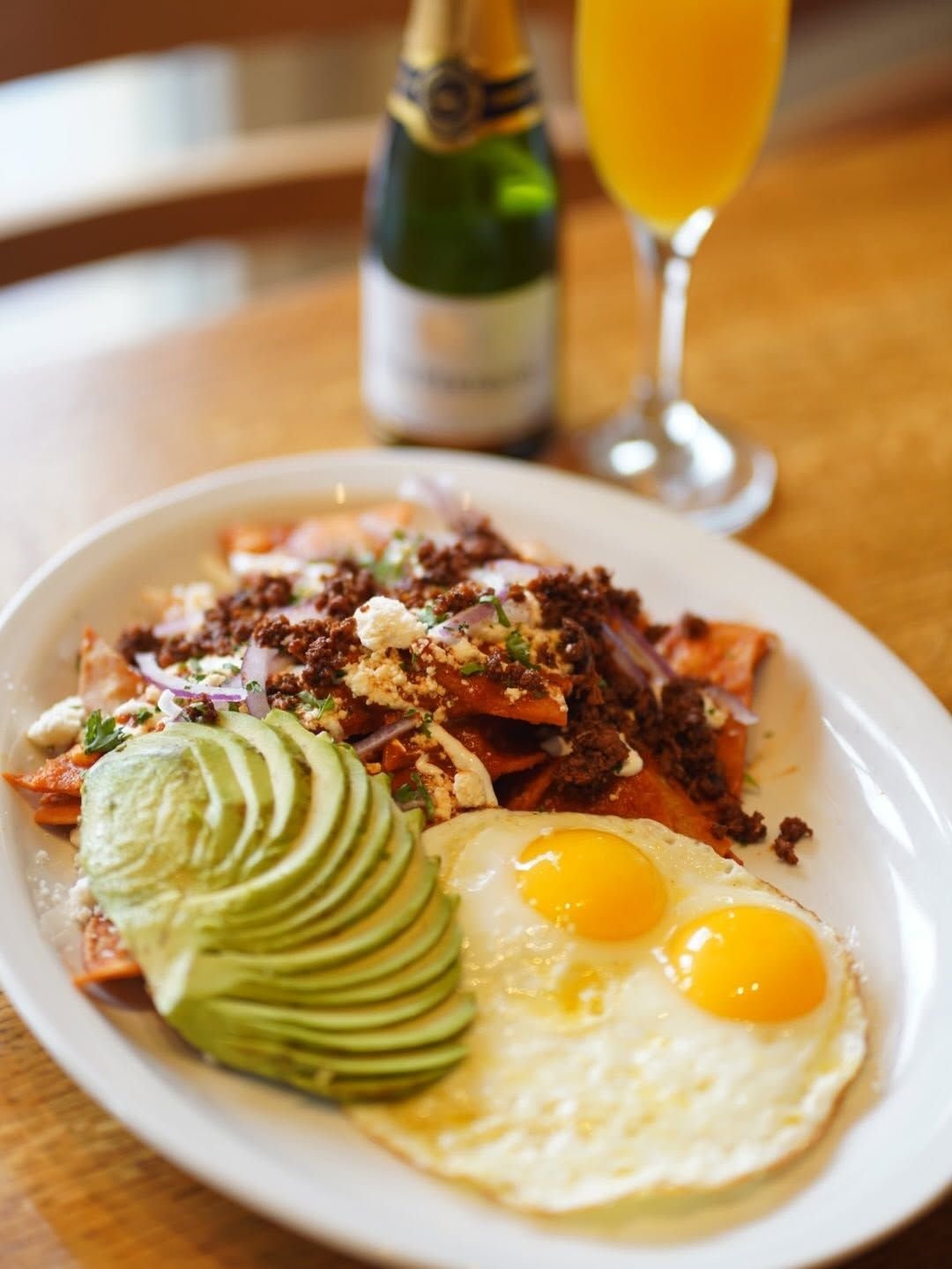 Chorizo chilaquiles with two eggs, avocado and cotija