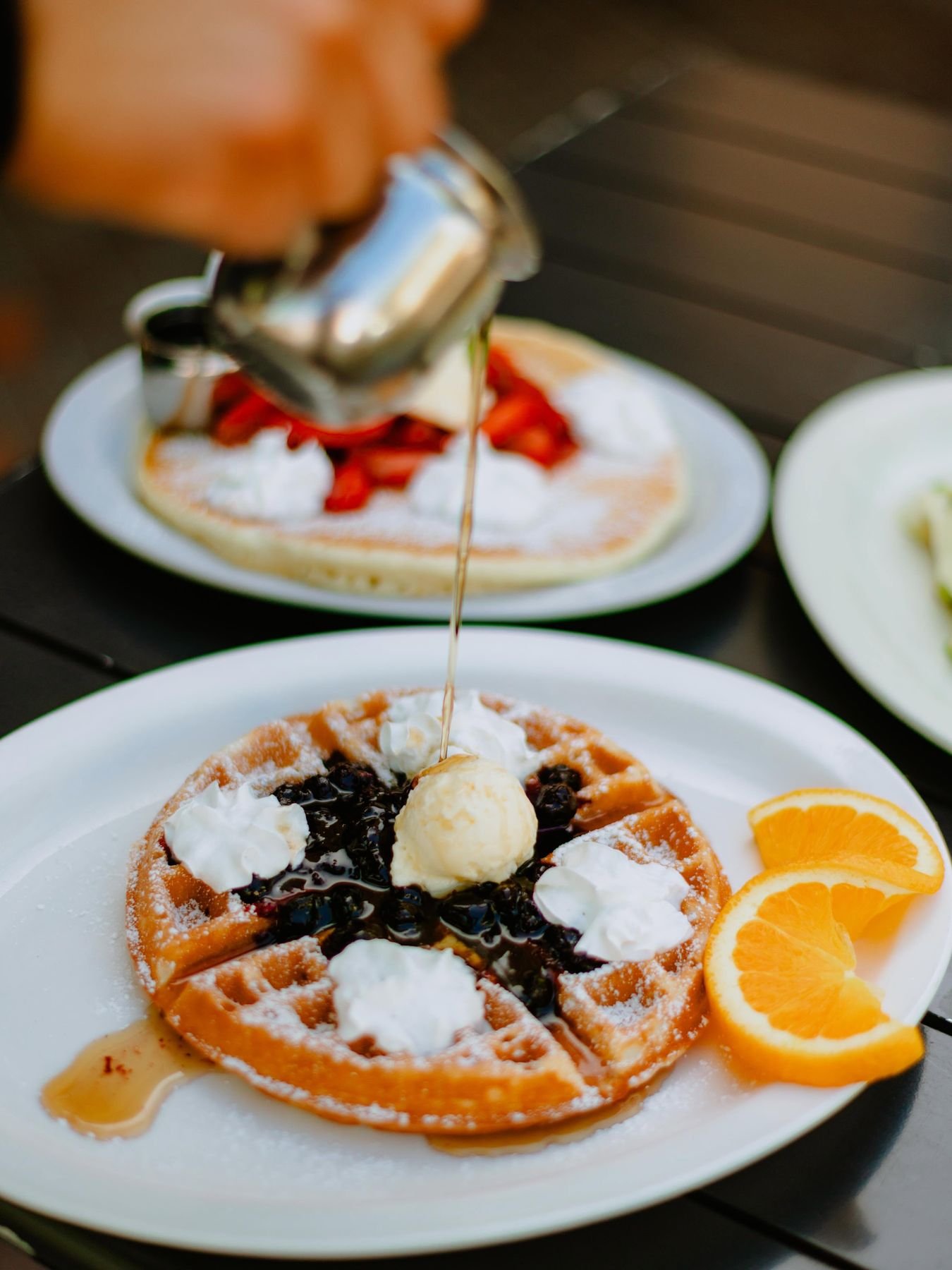 Blueberry waffle à la mode with ice cream and orange